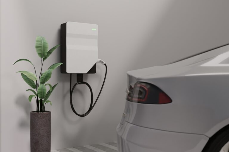 a home EV charger installed in a residential garage with a white car parked next to it