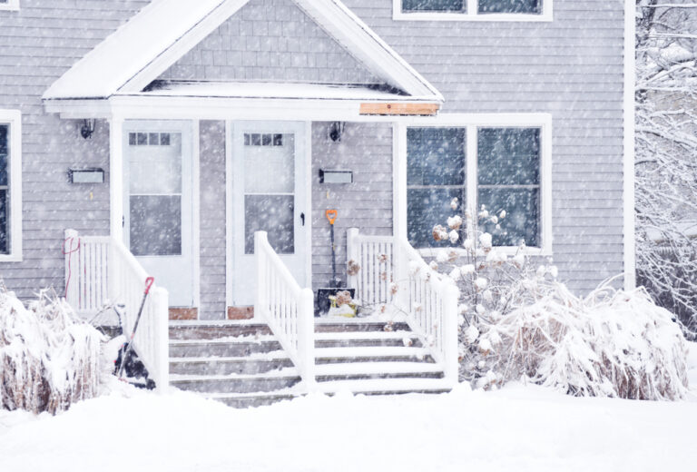 a home covered in snow during heavy snowfall