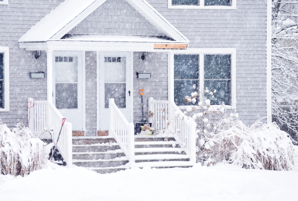 a home covered in snow during heavy snowfall