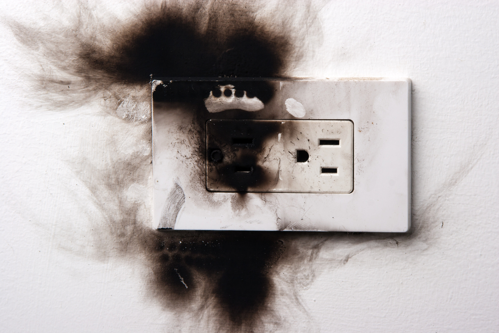scorch marks and burning smell around electrical outlet